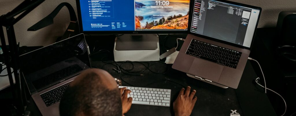 man in blue shirt using computer
