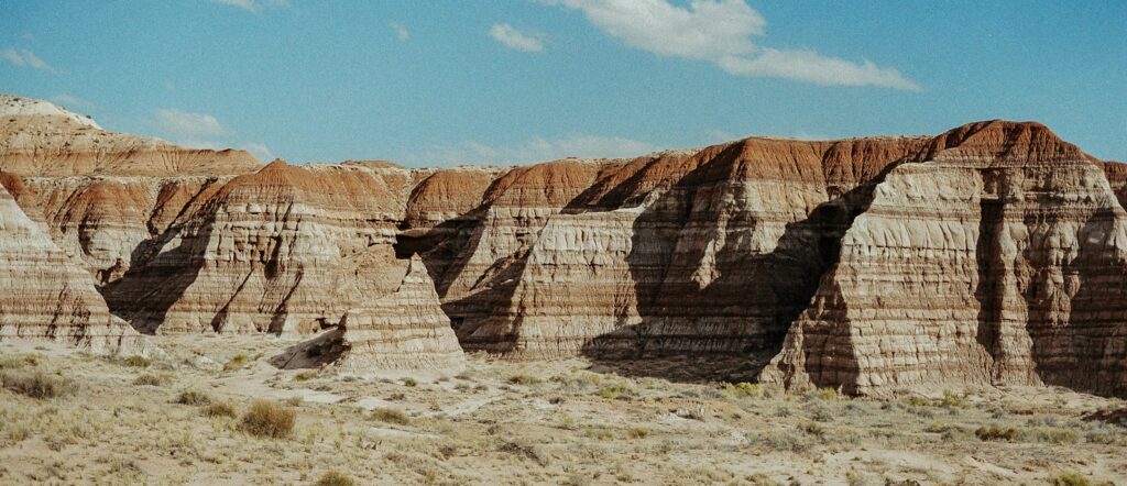 Layered sandstone cliffs under a clear blue sky