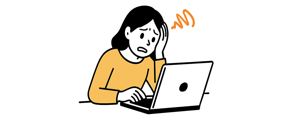PCの前で悩んでいる女性