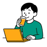 PCを眺めながらジュースを飲む人
