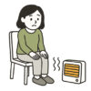 足元ヒーターで温まる人